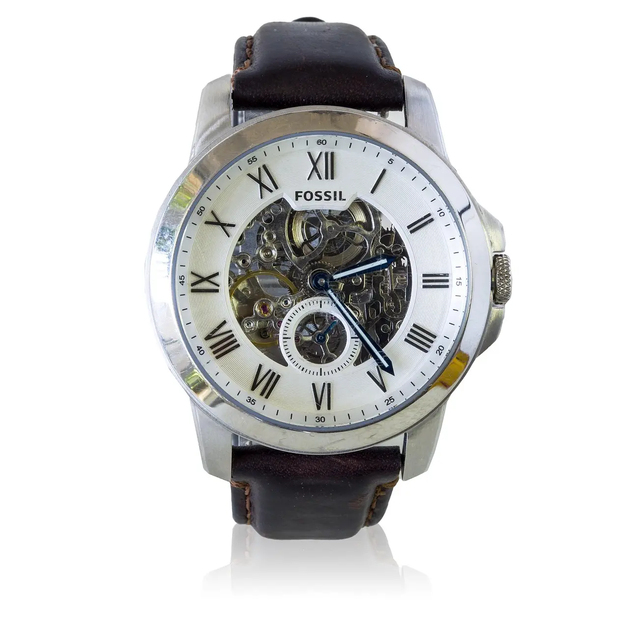 A silver Fossil wristwatch with a brown leather strap, Roman numerals, and an exposed mechanical movement showcases true horology on a white background.