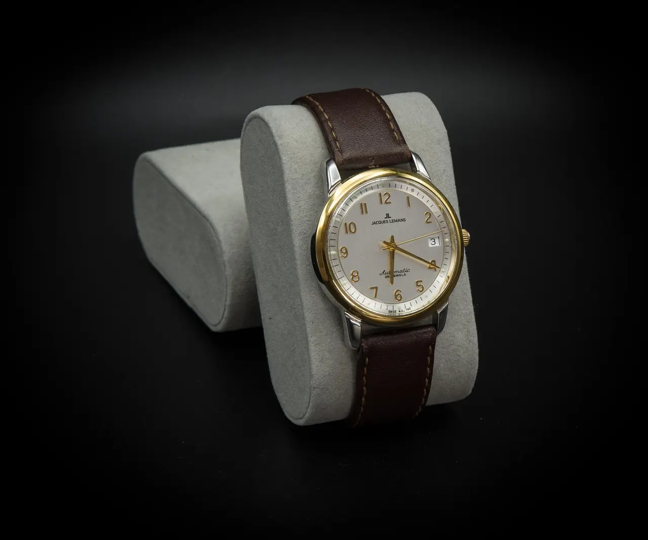 Classic two-tone automatic wristwatch with gold bezel, white dial.