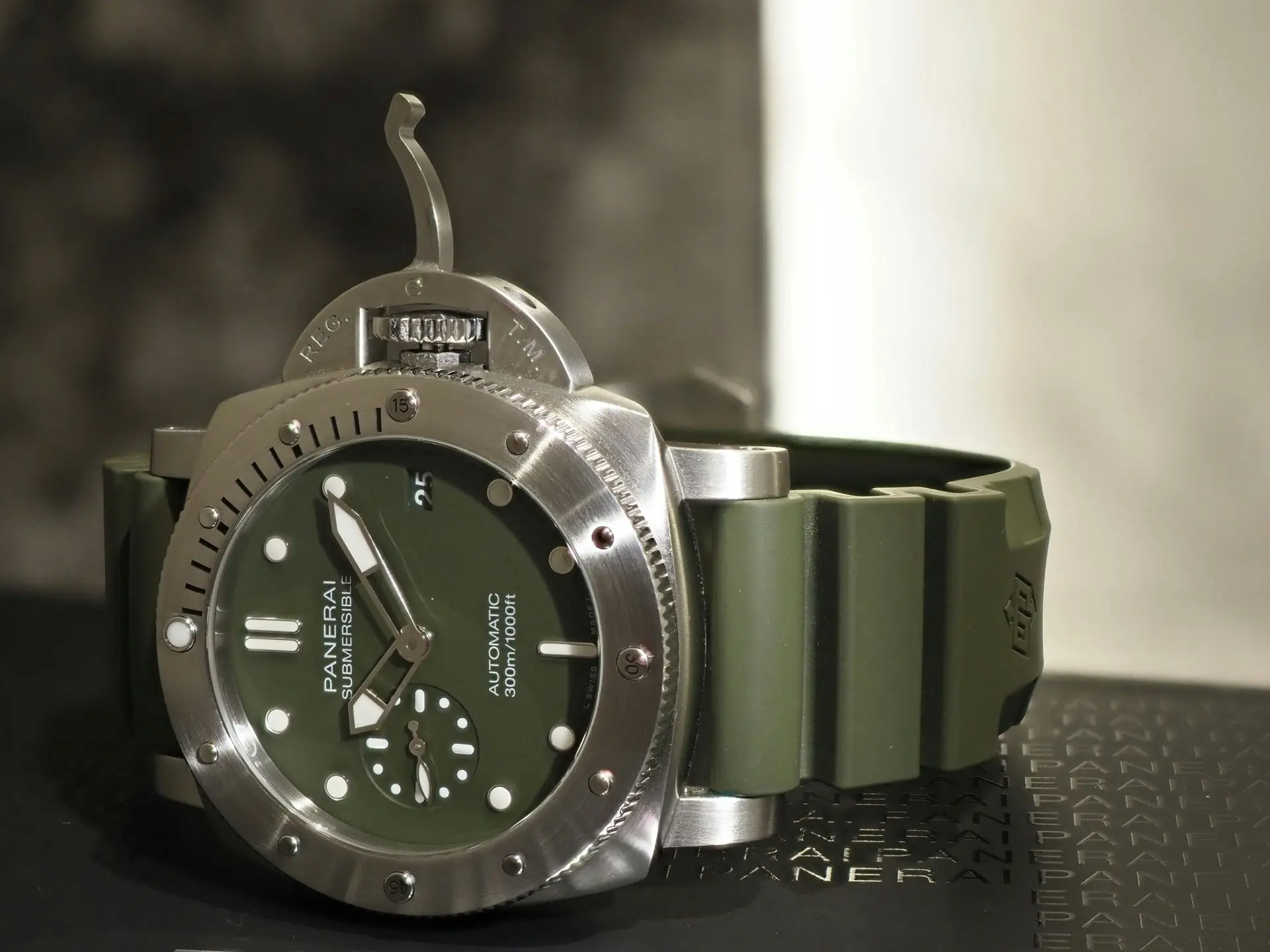 Panerai dive watch with a green rubber watch strap on display