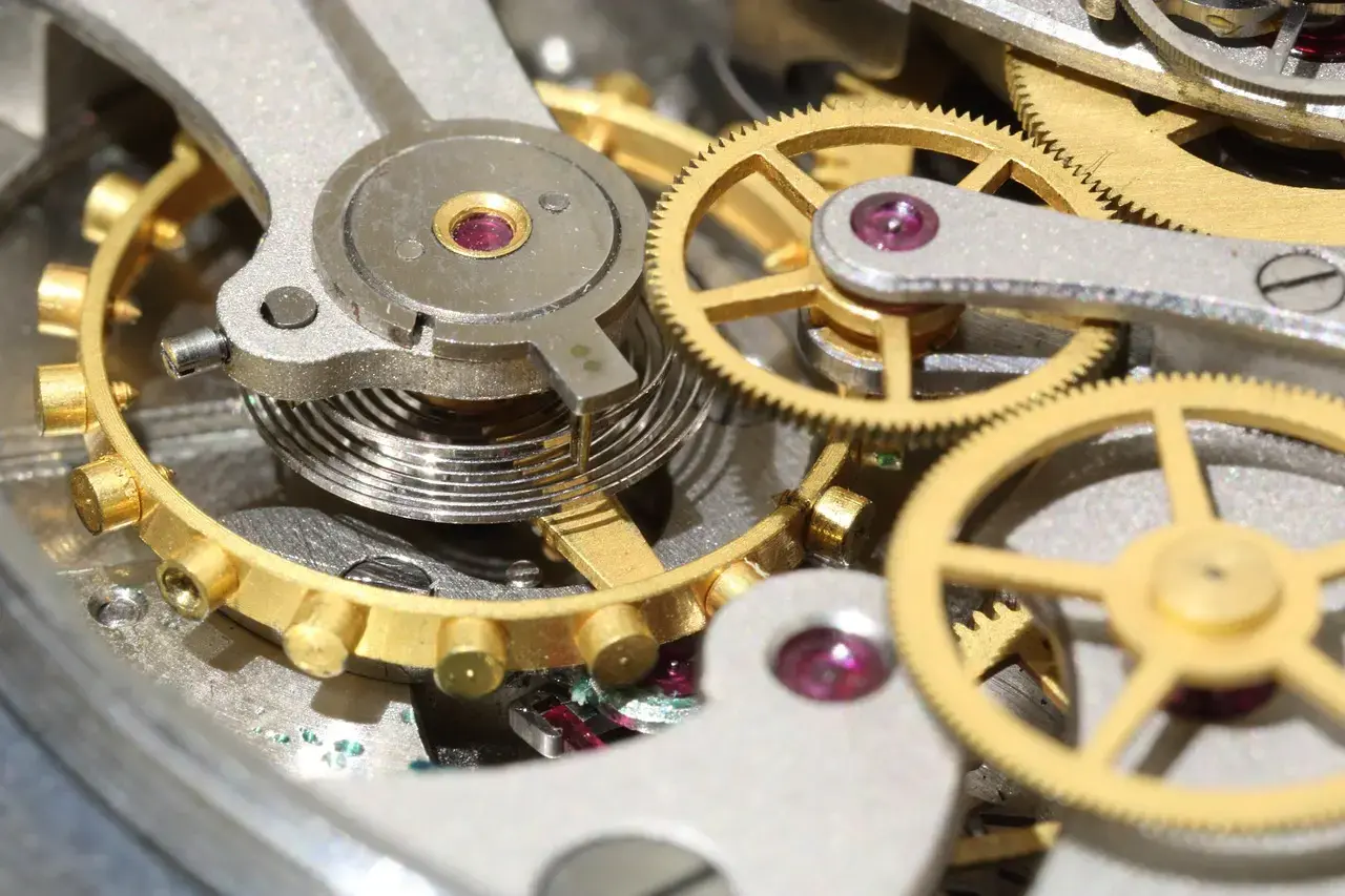 Watch Ticking – Close-Up Mechanical Movement Close-up view of a mechanical watch movement showing gears and escapement ticking