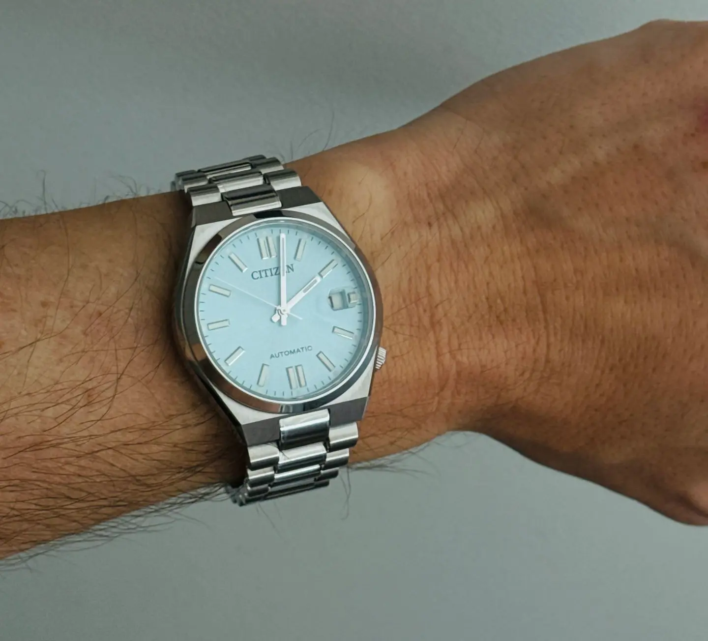 Close-up of a wrist wearing a silver Citizen watch, showing proper case size, thickness, and strap fit for a balanced and comfortable wristwatch look.