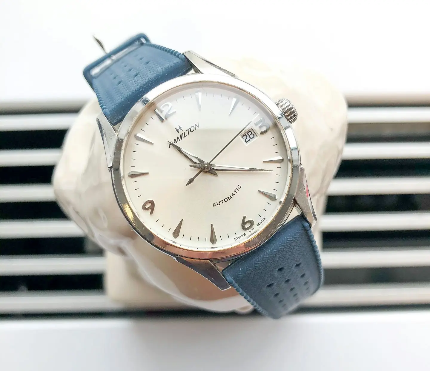 American international automatic watch brand showcased with a Hamilton automatic timepiece on a blue