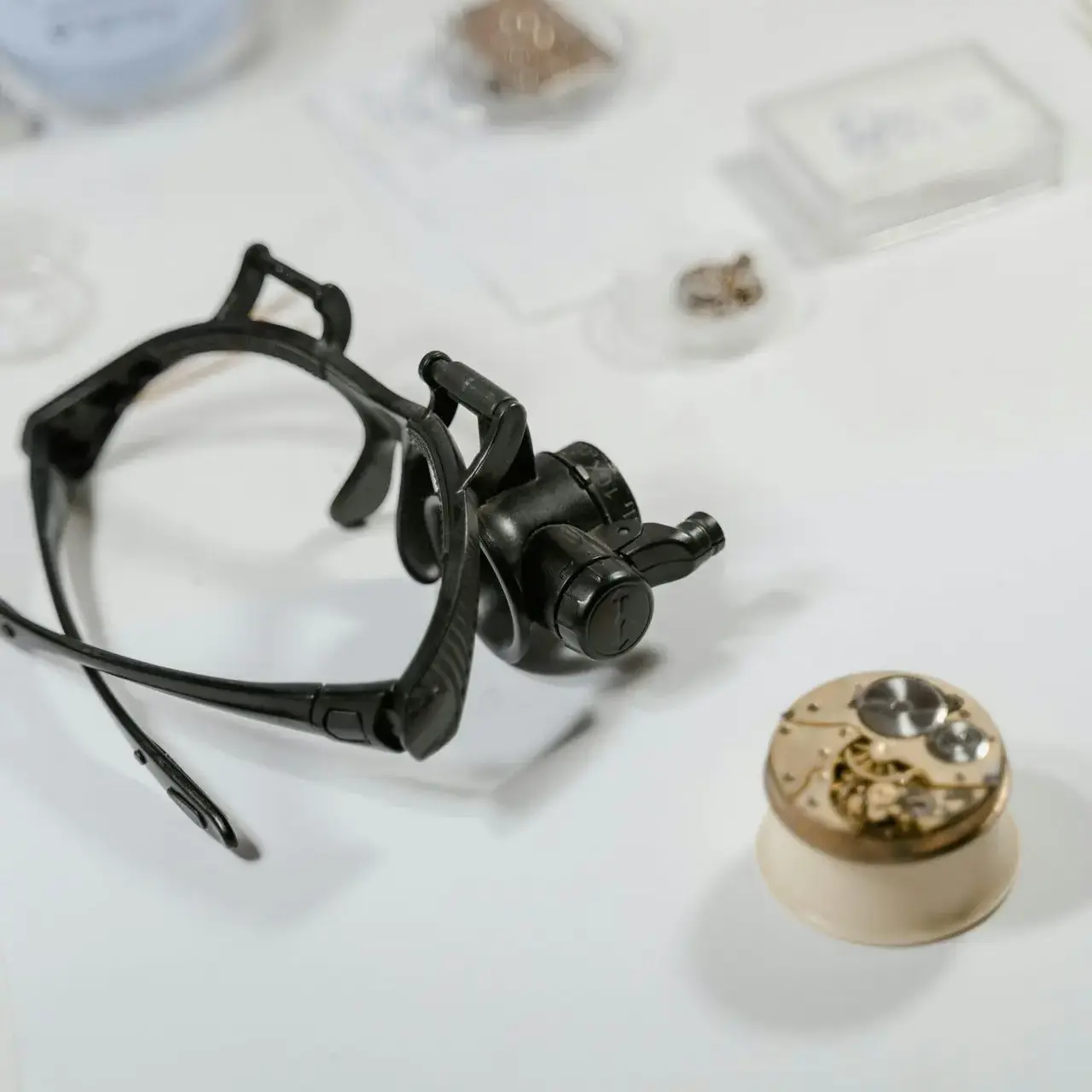 Watchmaking tools and watch movement on a table