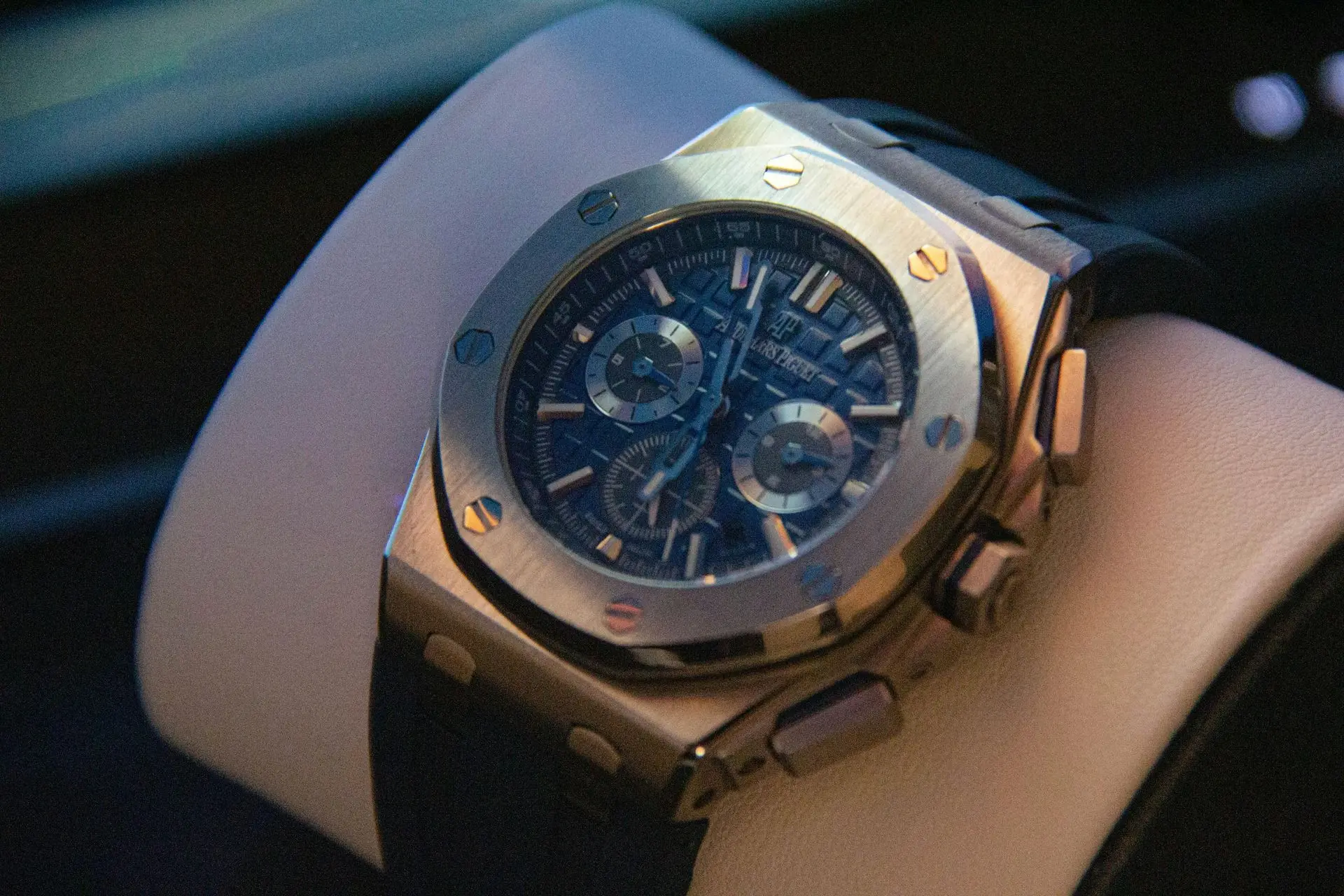 Audemars Piguet Royal Oak automatic luxury steel watch with octagonal bezel, exposed screws, and tapisserie dial