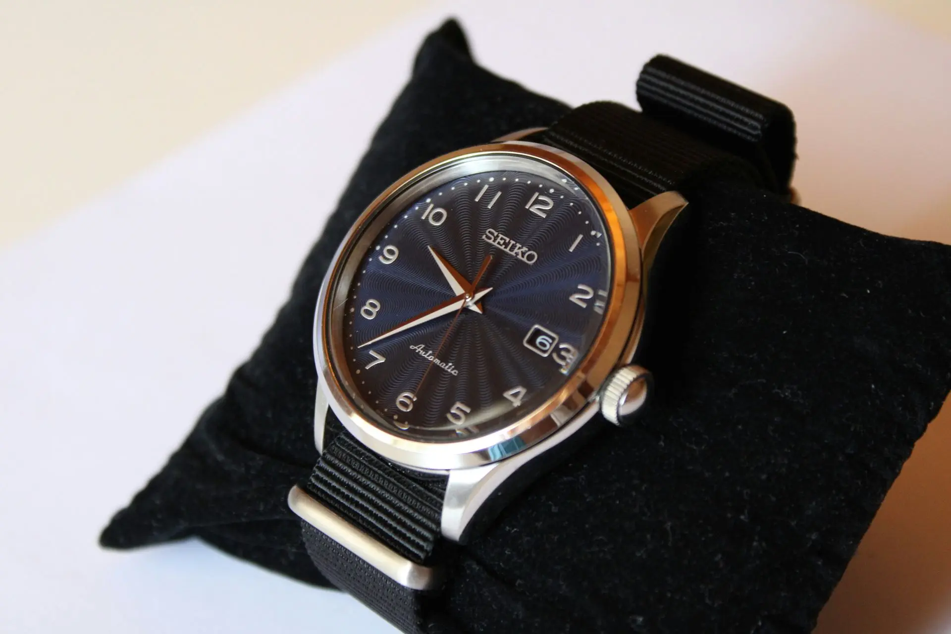Seiko automatic watch with textured black dial and fabric strap, featured among the best automatic watches for everyday wear