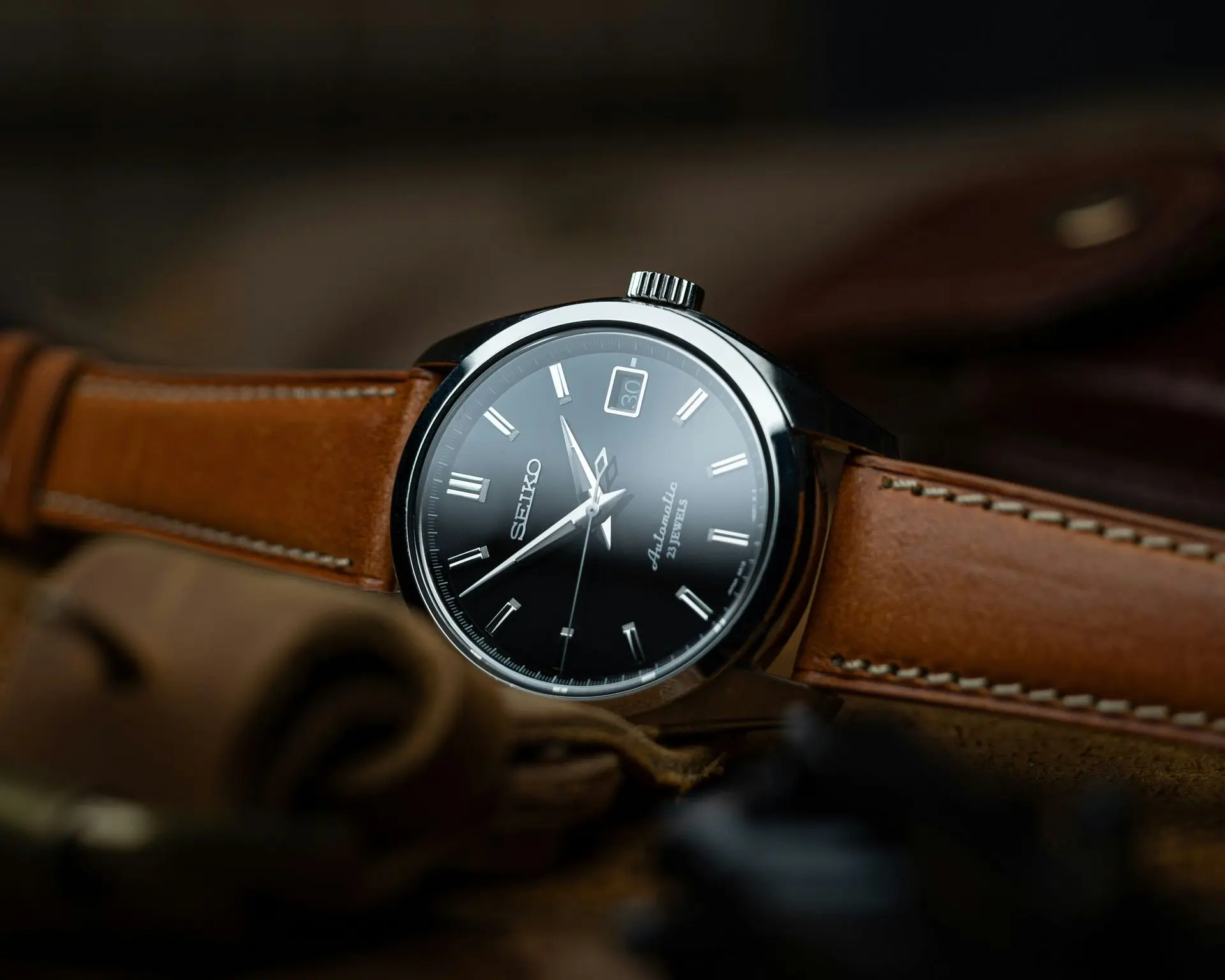 Seiko automatic dress watch with black dial and brown leather strap, close-up product shot