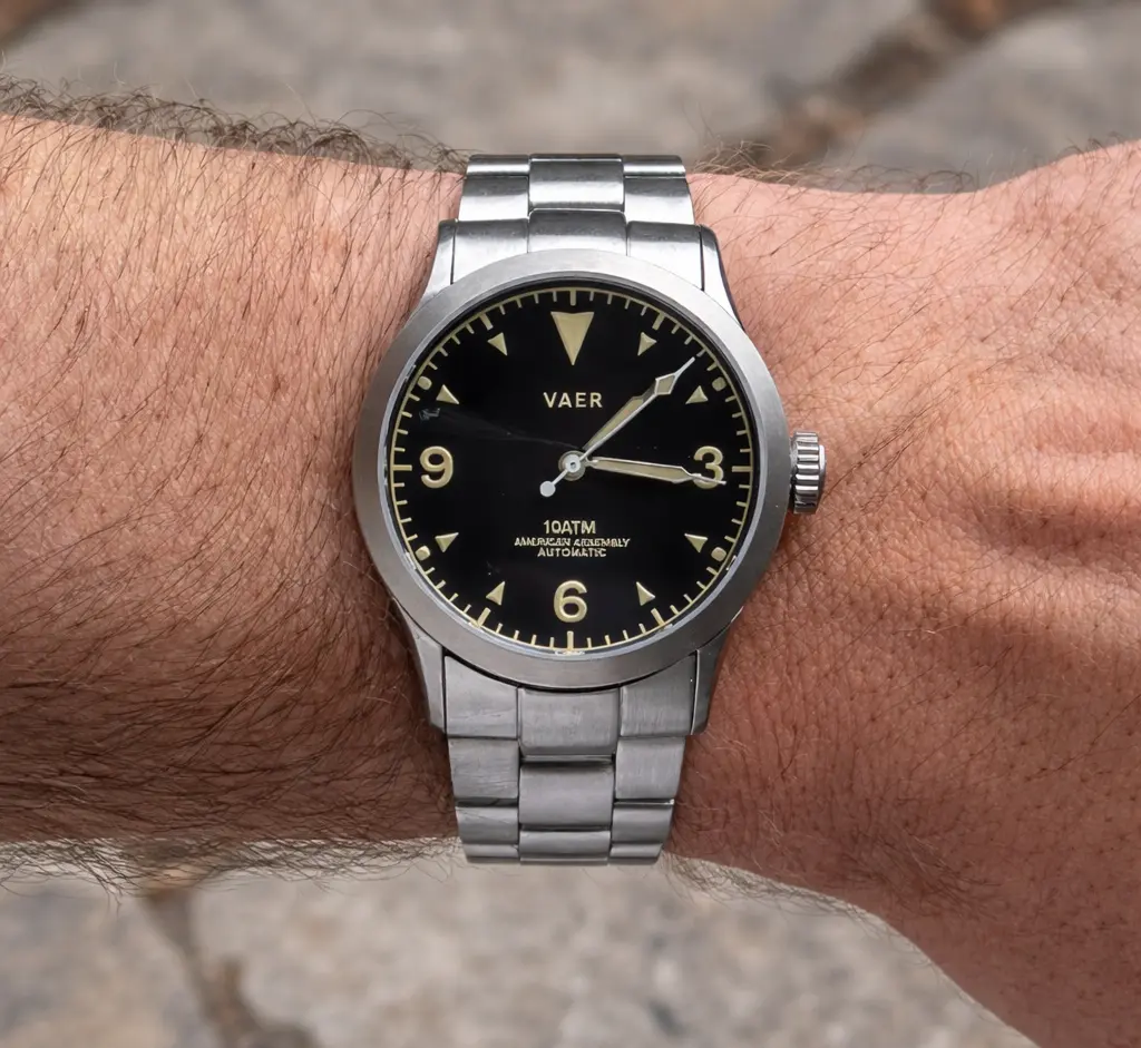 Vaer A5 automatic field watch with black dial, stainless steel case, and metal bracelet on wrist