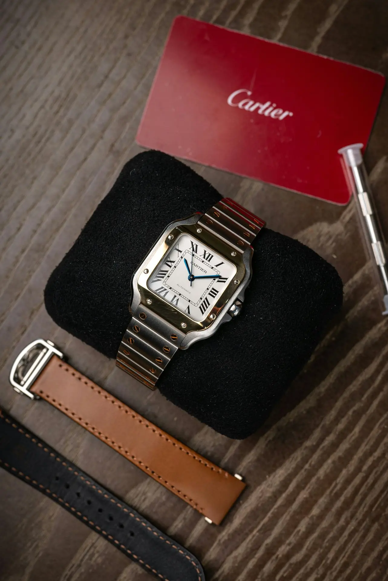 Luxury Automatic Watch – Durable Heirloom Mechanical Timepiece Luxury automatic wristwatch with Roman numeral dial on black cushion beside red warranty card