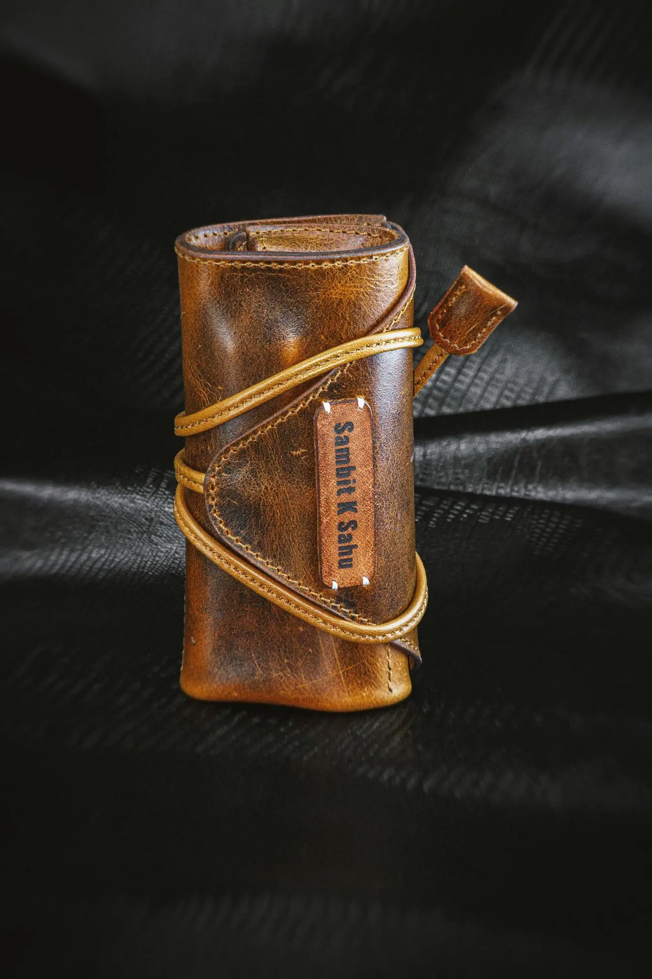 Compact Leather Watch Travel Case for Safe and Stylish Watch Protection Brown leather watch travel case with wrap-around strap for secure single watch storage