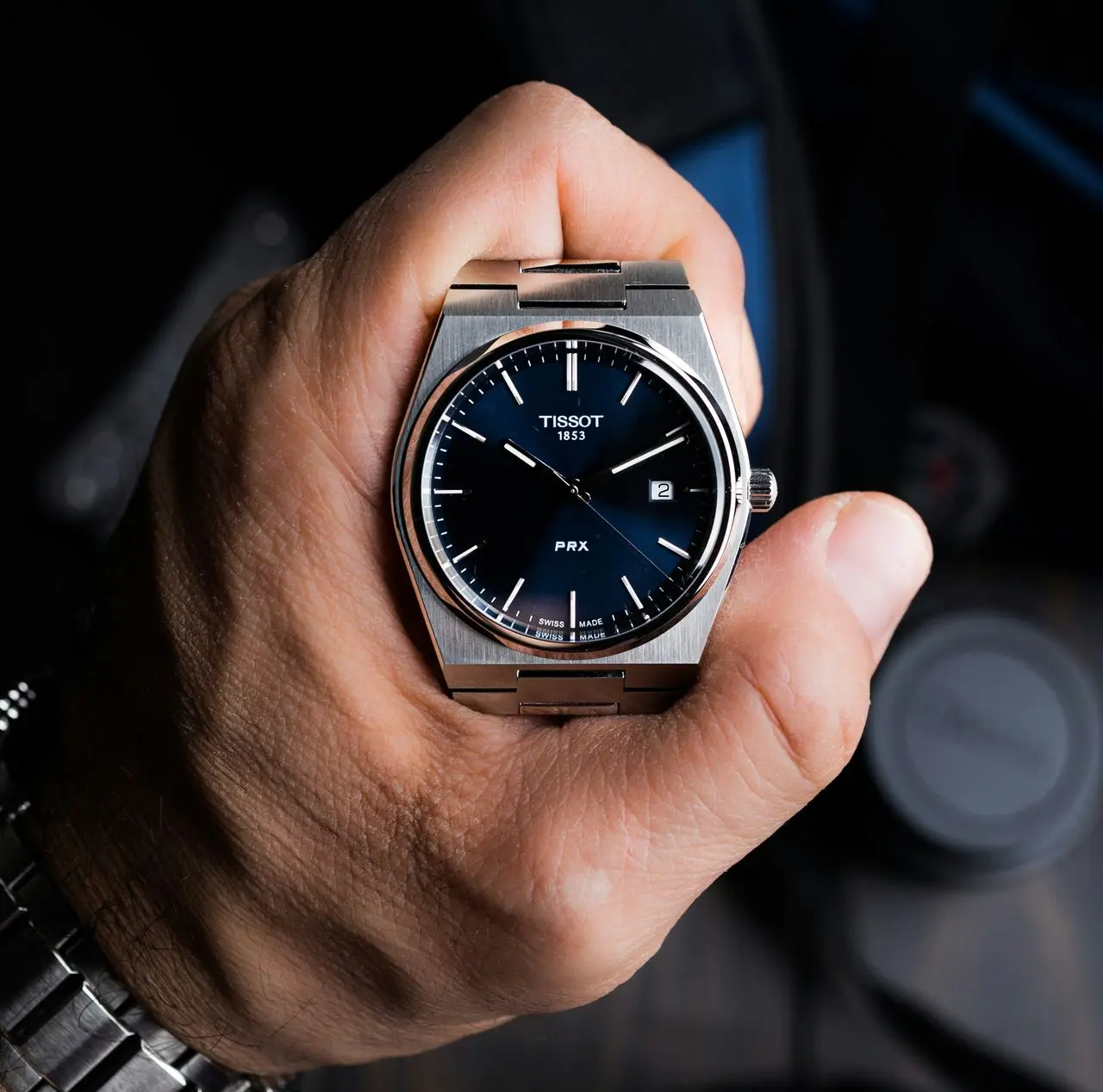 Tissot PRX Powermatic 80 automatic watch with integrated stainless steel bracelet held in hand