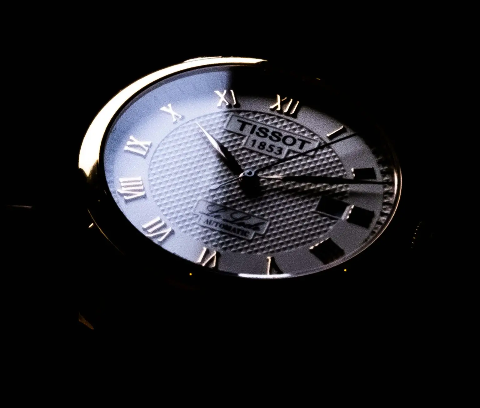 Tissot Le Locle automatic watch with Roman numerals and textured dial close-up