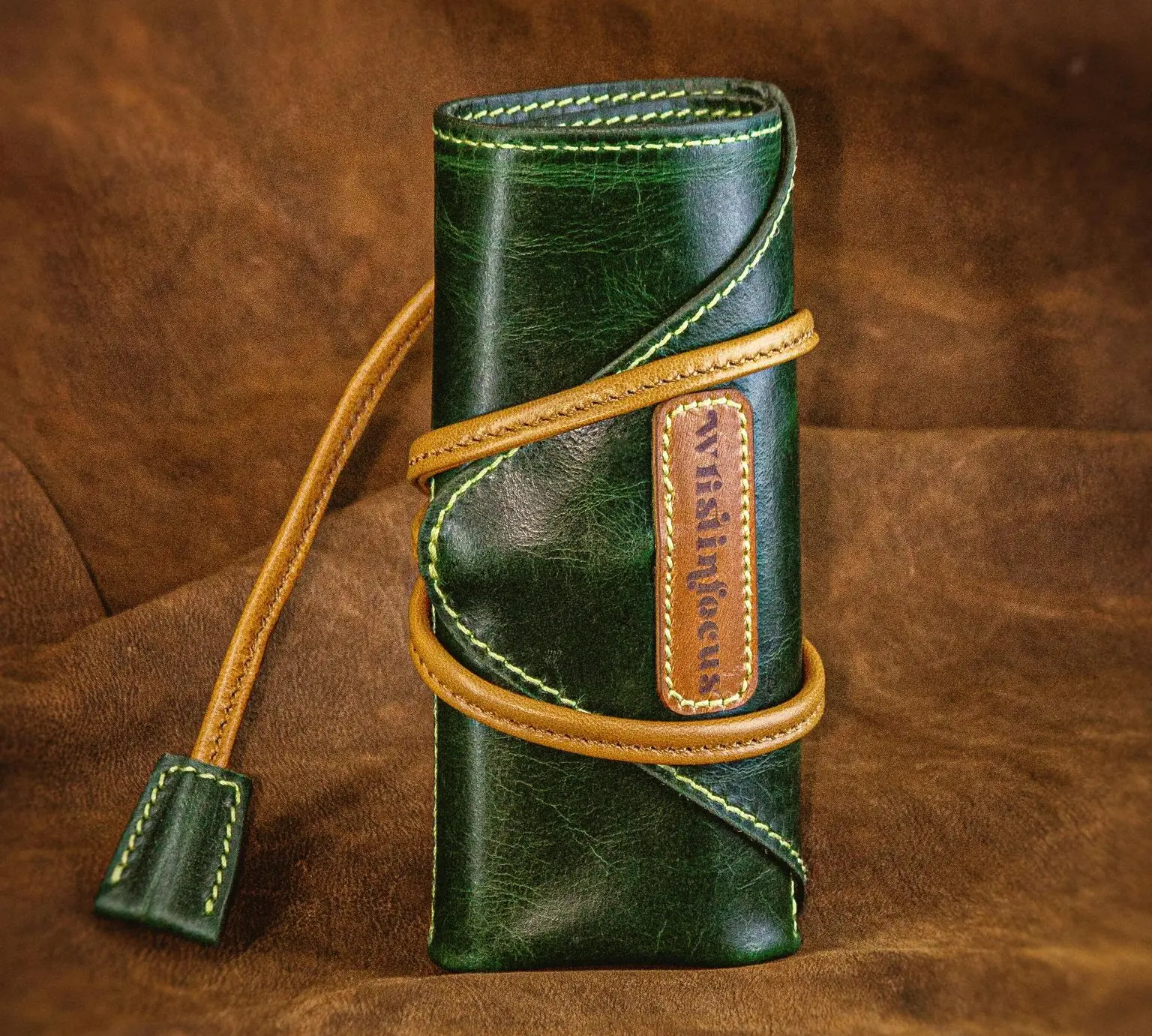 Brown leather watch roll case with multiple compartments holding watches for travel and storage