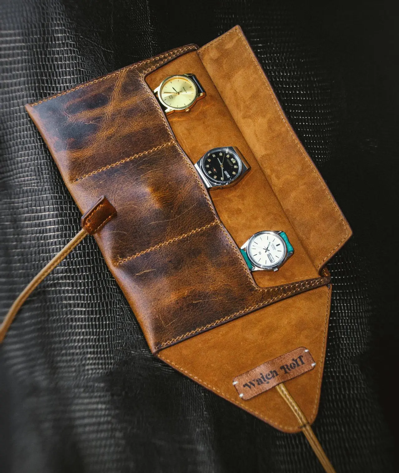 Leather watch roll case with multiple watches for travel and different user needs