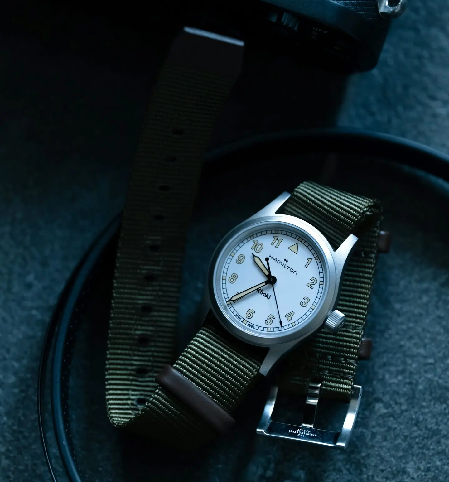 Hamilton Khaki Field Military Watch with Olive NATO Strap Hamilton Khaki Field military-style watch with olive NATO strap on dark tactical background