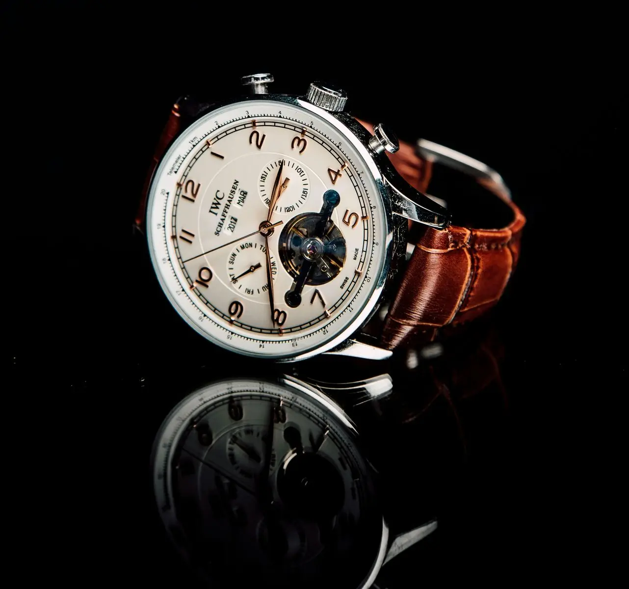 Luxury tourbillon watch complication with exposed rotating mechanical cage