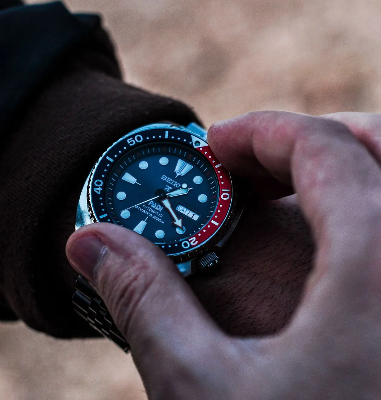 Automatic Watch Maintenance Tips for Long-Term Performance Automatic watch being worn and adjusted as part of proper watch maintenance and care practices.