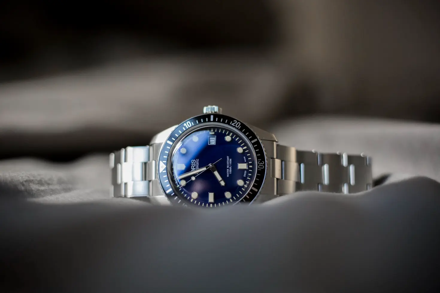 Minimalist watch collection featuring a stainless steel sports dive watch with a blue dial