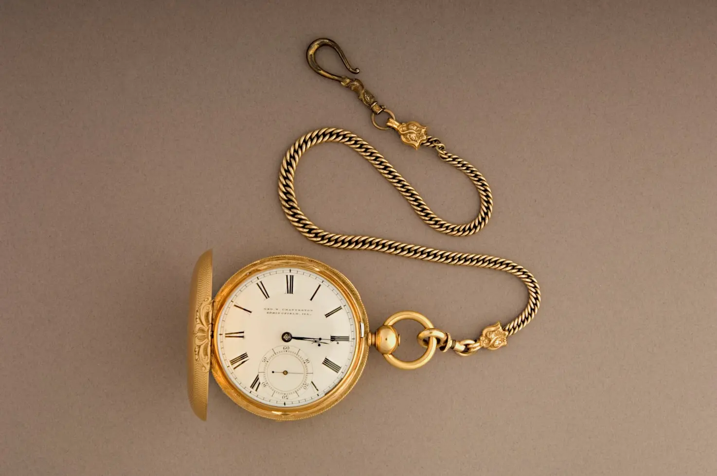 Vintage gold pocket watch with chain illustrating the history of pocket watches vs wristwatches