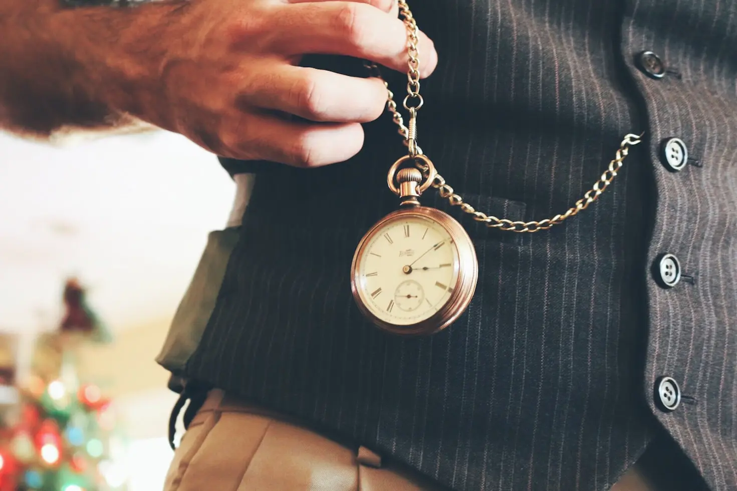 Vintage pocket watch worn on a gentleman's waistcoat illustrating the history of pocket watches and their popularity for centuries