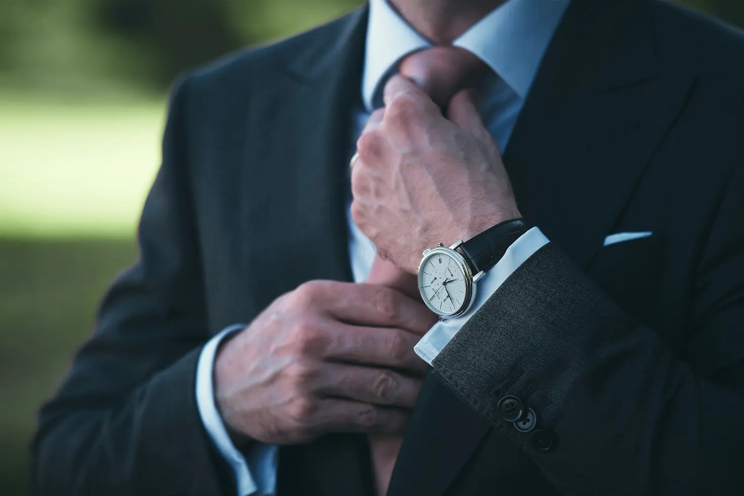 Business professional wearing a classic wristwatch, showing how wristwatches complement everyday wear and formal occasions