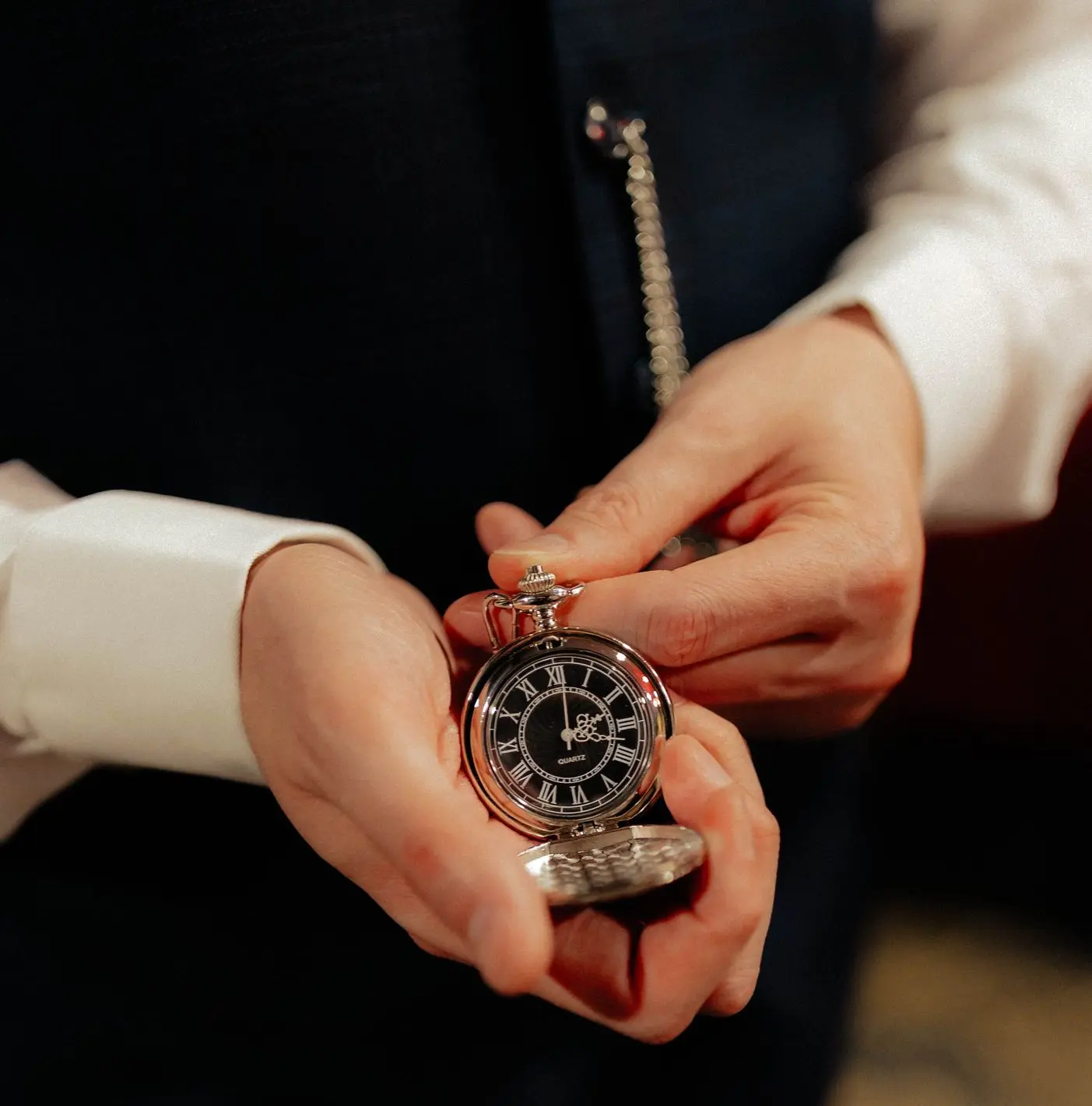 Elegant vintage pocket watch held in hand, illustrating the prestige, craftsmanship, and heirloom value of pocket watches