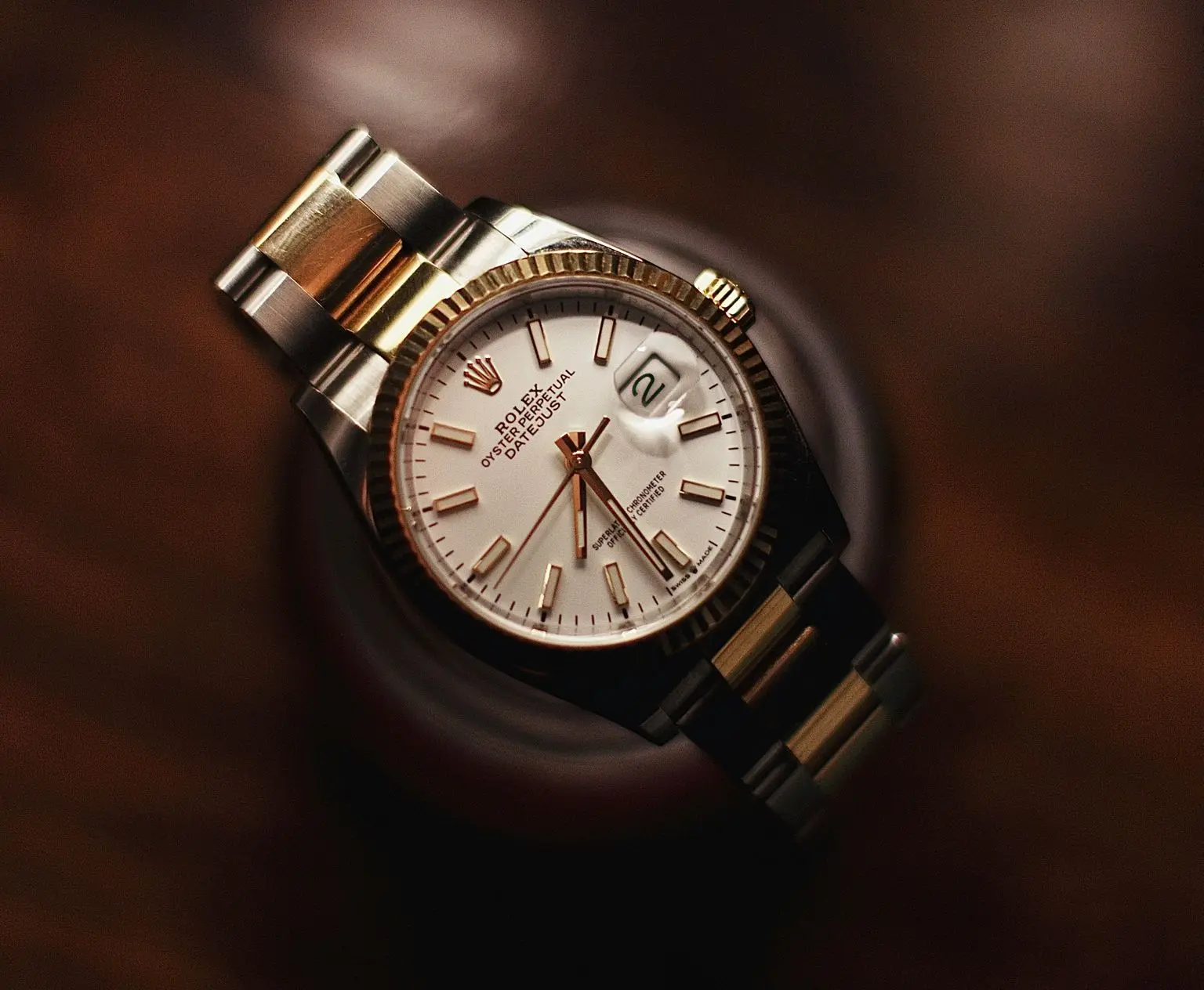 Rolex Crown Logo on Luxury Watch Dial Rolex watch with iconic crown logo on white dial