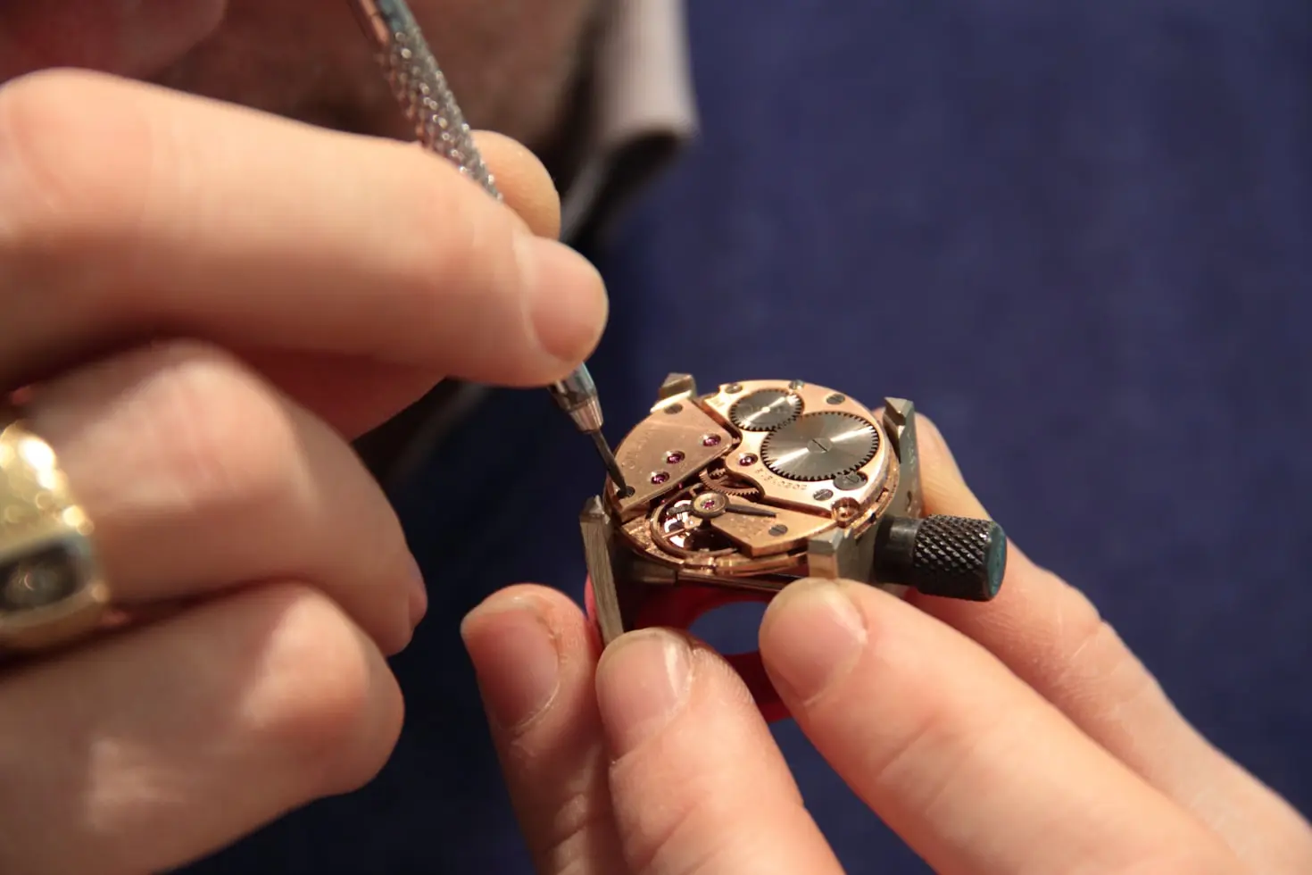 Watchmaker adjusting a mechanical watch movement