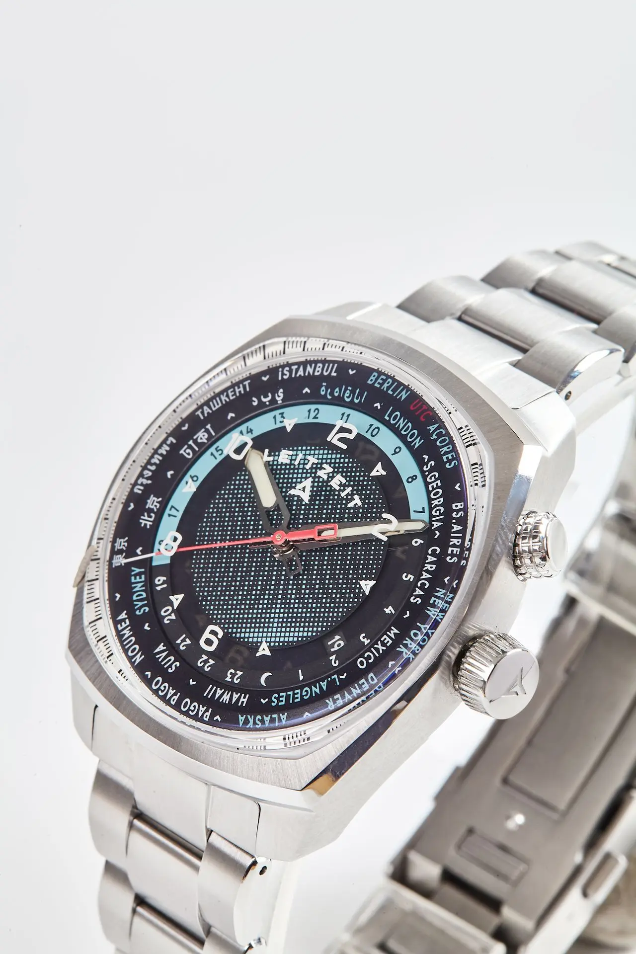 Close-up of the Axis Mundi Worldtimer with dark blue dial, dual crowns and stainless steel bracelet