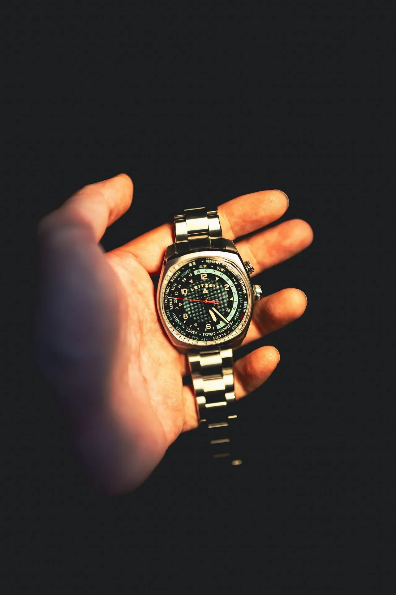 Axis Mundi Worldtimer automatic watch shown on the wrist with stainless steel bracelet