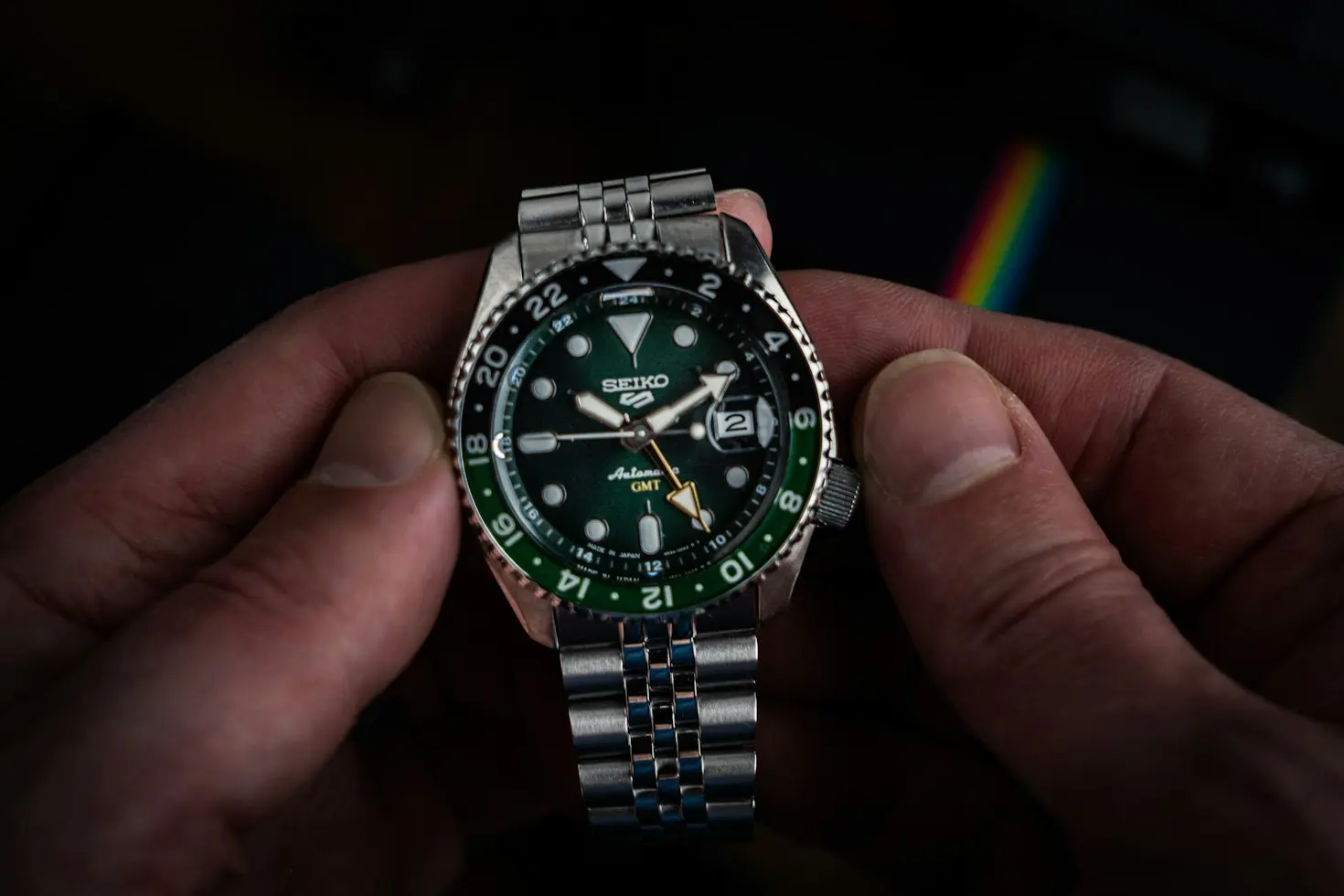 Close-up of a Seiko GMT watch featuring a 24-hour bezel and an additional GMT hand for tracking a second time zone.