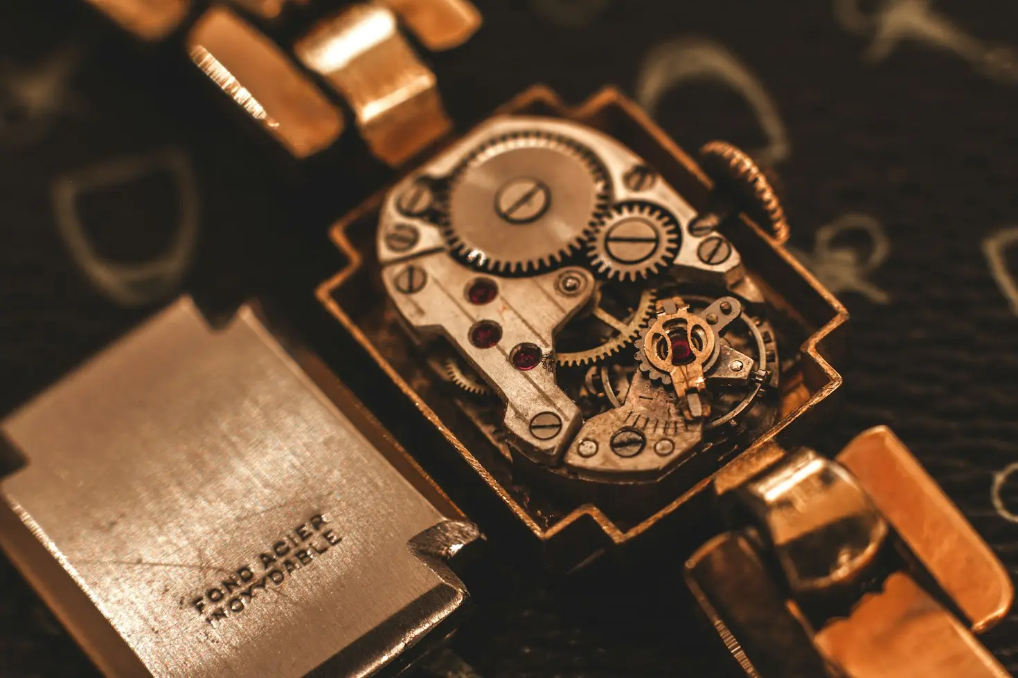 Close-up of a mechanical watch movement showing intricate gears, screws, and jewels with vintage-inspired detailing