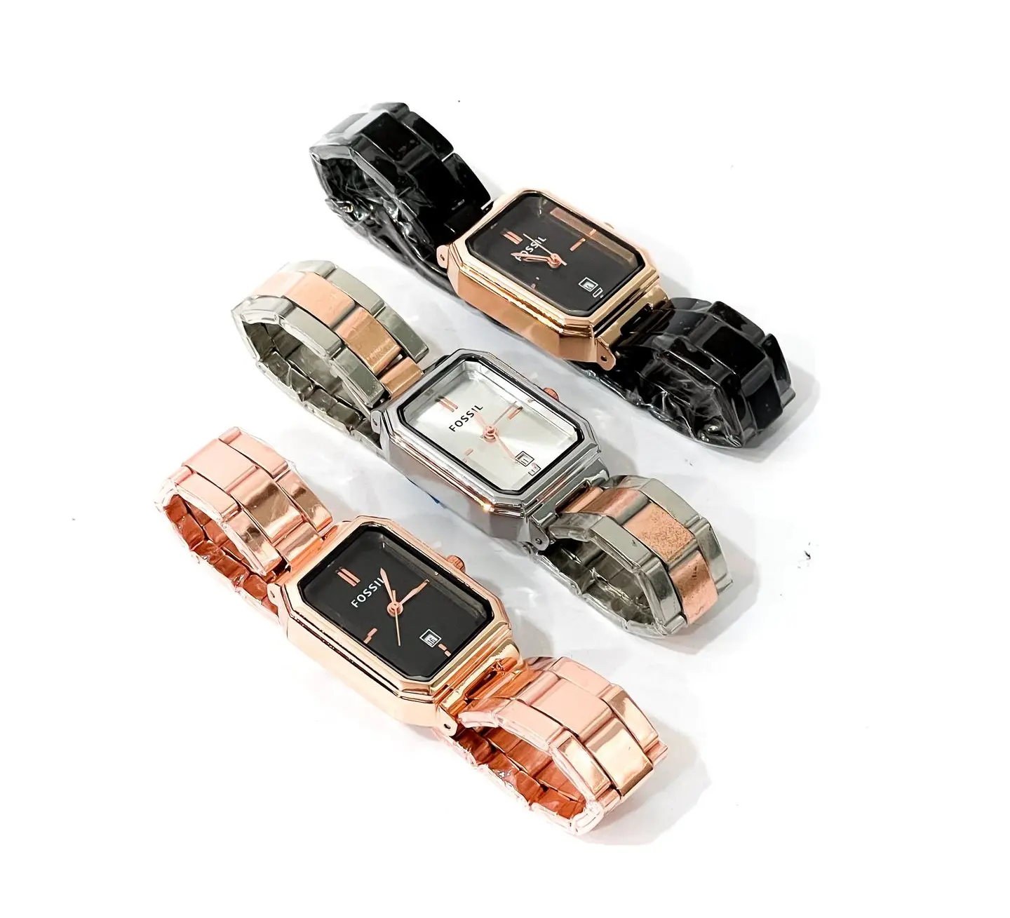 Art Deco-Inspired Rectangular Watches with Geometric Designs Three rectangular wristwatches with black and white dials, featuring geometric cases and mixed-metal bracelets